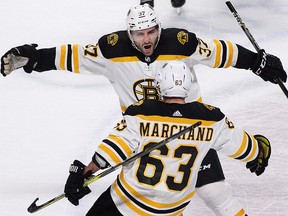 Boston Bruins' Brad Marchand (63) celebrates with teammate Patrice Bergeron after scoring against the Canadiens in Montreal, Saturday, January 13, 2018. (THE CANADIAN PRESS/Graham Hughes)