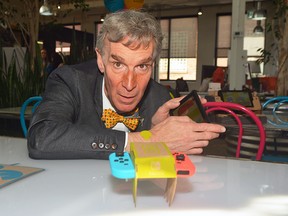 Bill Nye controls a car he created from cardboard utilizing the Nintendo Switch as part of the system's latest game, Nintendo Labo.