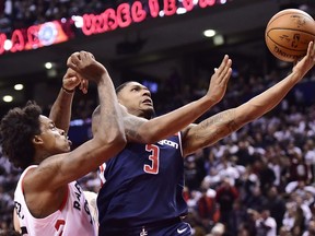 Wizards guard Bradley Beal (3) drives past Raptors centre Lucas Nogueira (92) during second half round one NBA playoff action in Toronto on Saturday, April 14, 2018. (Frank Gunn/THE CANADIAN PRESS)