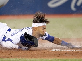 Lourdes Gurriel Jr. of the Toronto Blue Jays slides across home plate during MLB action against the Boston Red Sox at Rogers Centre on April 25, 2018 in Toronto. (Tom Szczerbowski/Getty Images)
