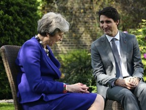 Britain's Prime Minister Theresa May, left, speaks with Canada's Prime Minister Justin Trudeau during bilateral talks at Downing Street, in London, Wednesday, April 18, 2018.