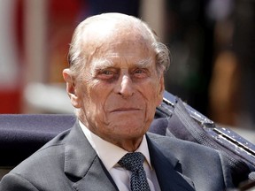 In this file photo dated Wednesday, July 12, 2017,  Britain's Prince Philip sits in a carriage in London.