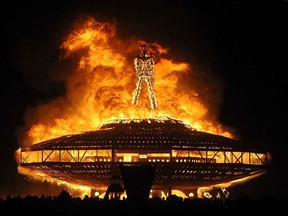 FILE - In this Aug. 31, 2013, file photo, the "Man" burns on the Black Rock Desert at Burning Man near Gerlach, Nev. Burning Man founder Larry Harvey remains hospitalized in critical condition after suffering a stroke. The Burning Man organization on Monday, April 9, 2018, said Harvey suffered a massive stroke on April 4. His prognosis is unknown, but the group says he is "receiving excellent round-the-clock medical care."