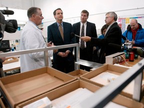 In this Nov. 12, 2003, file photo, CanadaDrugs.com director of pharmacy Robert Fraser, left, takes Minnesota Gov. Tim Pawlenty, second left, on a tour of the internet pharmacy CanadaDrugs.com in Winnipeg. (AP Photo/Ruth Bonneville, File)
