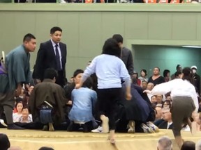In this screenshot, female first responders enter the sumo ring after Maizuru mayor Ryozo Tatami, 67, collapsed while making a speech on Apr. 4, 2018.