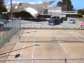 In this screenshot, surveillance video captures the moment strong winds blow the roof off Haviland Grade School in Haviland, Kan. on Apr. 3, 2018.