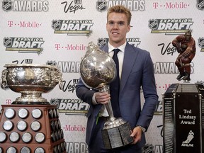 Connor McDavid of the Edmonton Oilers poses with the Art Ross Trophy, left, the Hart Memorial Trophy, centre, and the Ted Lindsay Award after winning the honours during the NHL awards ceremony Wednesday, June 21, 2017, in Las Vegas. (THE CANADIAN PRESS/AP-John Locher)