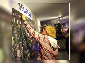 Justin Bieber signs a message board at the Stratford Perth Museum on Friday, April 27, 2018 in this handout photo. Justin Bieber's grandparents are known to frequent an exhibit on him in his hometown of Stratford, Ont. But on Friday the venue got an unexpected visit not just from them, but also from the pop superstar himself.THE CANADIAN PRESS/HO, John Kastner