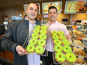Alex Halat, local philanthropist and from the Chestermere/ Langdon Oilmen's Assoc (L) and Andrew Marriott, Chestermere Tim Horton's owner/ franchisee pose in Chestermere, east of Calgary on Friday, April 13, 2018.