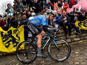 Belgian Michael Goolaerts competes on the 'Muur van Geraardsbergen' cobblestone road in Geraardsbergen, during the Tour of Flanders one day cycling race on April 1, 2018. (Getty Images)