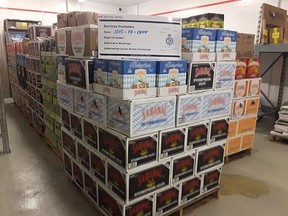 In this Twitter photo, Canada Border Services Officers show off 6 pallets of undeclared beer seized at the St-Bernard-de-Lacolle border crossing.
