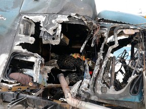 The cab of the 18-wheeler that exploded is left damaged after an accident at Interstate 30  in Dallas early Friday, April 6, 2018. (David Woo/The Dallas Morning News via AP)