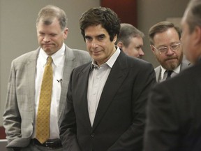Illusionist David Copperfield, center, appears at the Regional Justice Center in Las Vegas before opening statements in a civil trial on Friday, April 13, 2018.