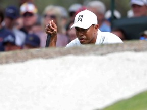Tiger Woods lines up his putt on seven during the second round of the Masters at Augusta National Golf Club on April 6, 2018.