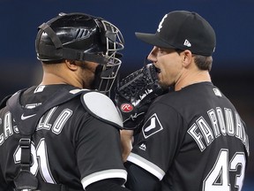 Danny Farquhar. right, of the Chicago White Sox talks with catcher Welington Castillo during MLB action against the Toronto Blue Jays at Rogers Centre on April 2, 2018 in Toronto. (Tom Szczerbowski/Getty Images)