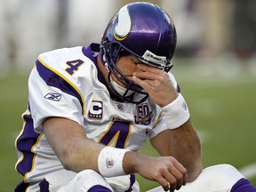 In this Oct. 31, 2010, file photo, Minnesota Vikings quarterback Brett Favre rubs his eyes after being hit  in Foxborough, Mass. (AP Photo/Winslow Townson, File)