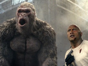 This image released by Warner Bros. shows Dwayne Johnson in a scene from "Rampage."  Johnson's arcade game-inspired "Rampage" crept past last week's top film "A Quiet Place" to take the No. 1 spot on the box office charts. (Warner Bros. via AP)