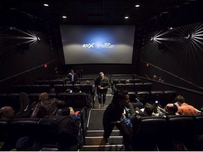 People mill about inside a Cineplex theatre as it opens its first 4DX sensory experience theatre in Toronto on Friday, November 4, 2016. The all-you-can-watch company MoviePass that's been dubbed by some as a "Netflix for theatres" hasn't revealed plans to launch in Canada, but a competitor that's facing a patent infringement lawsuit is now offering Canadians a service that it says is more sustainable and less too good to be true.
