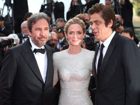 Director Denis Villeneuve, Emily Blunt and Benicio del Toro pose for photographers upon arrival for the screening of the film Sicario at the 68th international film festival, Cannes, southern France, Tuesday, May 19, 2015.