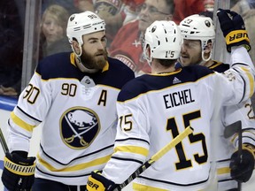 Buffalo Sabres' Sam Reinhart (23) celebrates with Ryan O'Reilly (90) and Jack Eichel 915) after scoring a goal during the third period of an NHL hockey game against the Florida Panthers, Saturday, April 7, 2018, in Sunrise, Fla. The Panthers won 4-3. (AP Photo/Lynne Sladky)