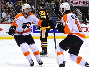 Scott Laughton of the Philadelphia Flyers celebrates Sean Couturier's goal against the Pittsburgh Penguins during Game 5 at PPG PAINTS Arena on April 20, 2018