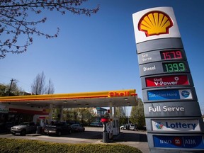 The price of a litre of gasoline of $1.579, an all-time high for the city, is displayed on a sign as motorists fuel up at a Shell gas station in Vancouver, B.C., on Sunday April 22, 2018.