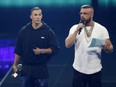 In this April 12, 2018 photo German rappers Kollegah & Farid Bang receive the "Hip-Hop/Urban national" award during the 2018 Echo Music Awards ceremony in Berlin. (Axel Schmidt/Pool Photo via AP)