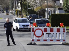 A street is blocked in Paderborn, Germany, Sunday, April 8, 2018. More than 26,000 people were asked to leave their homes in the western German town of Paderborn, two hospitals, a university and several nursing homes were evacuated so specialists could remove a World War II-era bomb discovered during construction work.