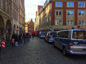 Police vans stand in downtown Muenster, Germany, Saturday, April 7, 2018. German news agency dpa says several people were killed after a car crashes into the crowd in city of Muenster.  (dpa via AP) ORG XMIT: 90-022413