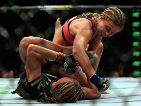 Felice Herrig (black top) and Paige VanZant (pink top) fight in their women's strawweight bout during the UFC Fight Night event at Prudential Center on April 18, 2015 in Newark, New Jersey.