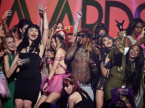 Audience members join rapper Lil' Wayne (4th R) onstage as he performs during the 2018 Adult Video News Awards at The Joint inside the Hard Rock Hotel & Casino on January 27, 2018 in Las Vegas, Nevada. (Photo by Ethan Miller/Getty Images)