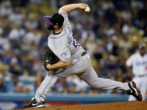 In this Sept. 8, 2017, file photo, Colorado Rockies relief pitcher Greg Holland throws against the Los Angeles Dodgers in Los Angeles. (AP Photo/Alex Gallardo, File)