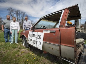 In this Tuesday, April 24, 2018 photo, Bill Braun, left, and his mother, Jo Braun, of Baldwin City, Kan., talk with current property owner Danny O'Neal about the half-car placed along the road on O'Neal's property in Edgerton, Kan., by Jo's husband Ray Braun about 20 years ago.  (Tammy Ljungblad/The Kansas City Star via AP)