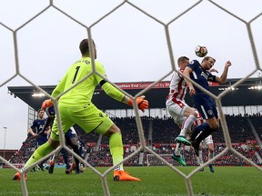 In this Saturday, April 7, 2018, file photo, Tottenham Hotspur's Harry Kane, right, attempts to get a touch on the ball during the English Premier League soccer match against Stoke City. (Nigel French/PA via AP, File)