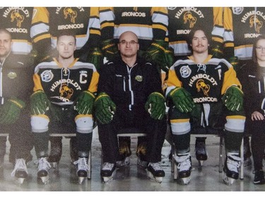 Head coach and general manager Darcy Haugan, centre, is shown in team photo of the 2016/2017 Humboldt Broncos hockey team as it hangs in Elgar Petersen Arena in Humboldt, Sask., on Saturday, April 7, 2018. The head coach of the Humboldt Broncos hockey team is among 14 dead following a horrific bus crash in Saskatchewan. Darcy Haugan was on the junior hockey team's bus Friday on the way to a playoff game in northeastern Saskatchewan when it collided with a truck.