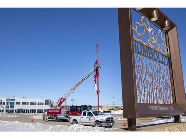 The Humboldt Fire Department lower a large Canadian flag to half-mast on the eastern entrance to the community on Highway 5 in Humboldt, Sask., on Saturday, April 7, 2018. RCMP say 14 people are dead and 14 people were injured Friday after a truck collided with a bus carrying a junior hockey team to a playoff game in northeastern Saskatchewan. Police say there were 28 people including the driver on board the Humboldt Broncos bus when the crash occurred at around 5 p.m. on Highway 35 north of Tisdale.