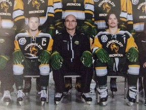 Head coach and general manager Darcy Haugan, centre, is shown in team photo of the 2016/2017 Humboldt Broncos hockey team as it hangs in Elgar Petersen Arena in Humboldt, Sask., on Saturday, April 7, 2018. THE CANADIAN PRESS/Liam Richards