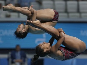 Canada's Jennifer Abel, front, and her teammate Francois Imbeau-Dulac perform during the mixed 3 meter springboard diving final at the 17th FINA World Championships 2017 in Budapest, Hungary, Saturday, July 22, 2017.