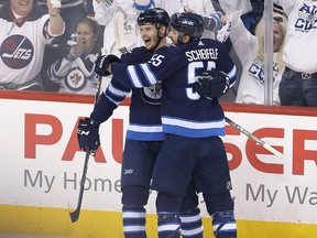 Mark Scheifele and Jacob Trouba of the Winnipeg Jets celebrate Trouba's goal during Game 5 on April 20, 2018