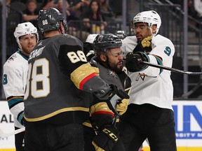 Evander Kane of the San Jose Sharks cross-checks Pierre-Edouard Bellemare of the Vegas Golden Knights at T-Mobile Arena on April 26, 2018 in Las Vegas. (Christian Petersen/Getty Images)