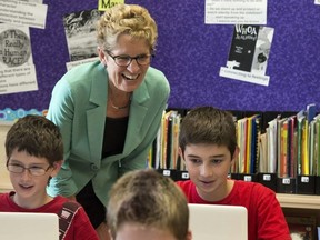 Ontario Liberal leader Kathleen Wynne checks in on students during a visit to Holy Cross school in Sault Ste. Maire, Ontario during a campaign stop on Tuesday May 20, 2014, 2014.