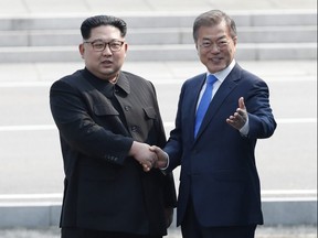 North Korean leader Kim Jong Un, left, shakes hands with South Korean President Moon Jae-in at the border village of Panmunjom in the Demilitarized Zone Friday, April 27, 2018. (Korea Summit Press Pool via AP)