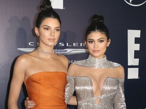 FILE - In this Jan. 8, 2017 file photo, Kendall Jenner, left, and Kylie Jenner arrive at the NBCUniversal Golden Globes afterparty in Beverly Hills, Calif. A lawsuit from a photographer Michael Miller, who was suing Kendall and Kylie Jenner's fashion label over T-shirts with the late rapper Tupac Shakur's image on them, is being dropped. A document filed in federal court Wednesday, April 4, 2018, says that both parties are asking a judge to dismiss the suit brought by Miller against the Kendall + Kylie label.