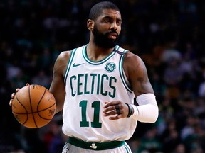 Kyrie Irving of the Boston Celtics dribbles the ball during an NBA game on Feb. 28, 2018
