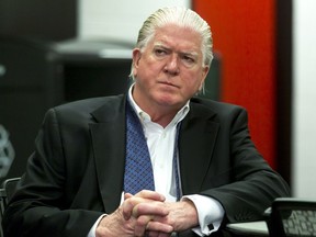 Calgary Flames president of hockey operations Brian Burke listens to a press conference at the Scotiabank Saddledome in Calgary, Alta., on Tuesday, May 3, 2016. The Flames had just fired head coach Bob Hartley and associate coach Jacques Cloutier. Lyle Aspinall/Postmedia Network