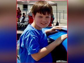 In this spring 2017 photo provided by Matthew Leach, his son, Andy Leach, poses at an auto race near Southaven, Miss. (Matthew Leach via AP)