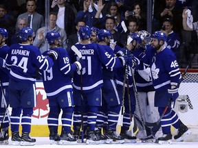 Maple Leafs goaltender Frederik Andersen is mobbed by teammates after a win over the Boston Bruins at the ACC on Tuesday, April 24, 2018. (Jack Boland/Toronto Sun)