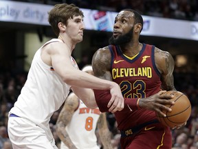 Cleveland Cavaliers' LeBron James, right, drives past New York Knicks' Luke Kornet Wednesday, April 11, 2018, in Cleveland. (AP Photo/Tony Dejak)