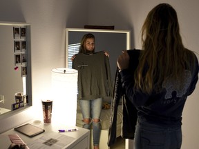 This April 5, 2018 photo shows Lizzy Martinez, 17, at her home in Bradenton, Fla. Martinez was asked by a school official at Braden River High School in Bradenton, Fla., to cover her nipples with band-aids, as she was causing a "distraction." (Tiffany Tompkins/Bradenton Herald via AP)