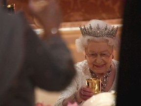Britain's Queen Elizabeth raises her glass during speeches at The Queen's Dinner, during the Commonwealth Heads of Government Meeting at Buckingham Palace in London, Thursday, April 19, 2018.